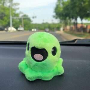Baby Slime Plush Riding on a Dashboard